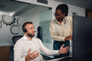 Customer service representatives working together in modern office