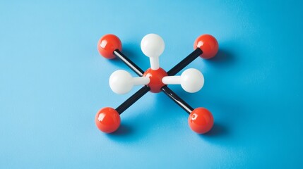 Fototapeta premium A chemistry-themed background showcasing chemical bonds and the molecular structure of water, featuring H2O model molecules made of plastic, isolated against a blue backdrop.