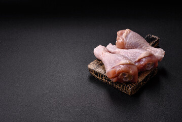 Raw chicken legs with salt, spices and herbs