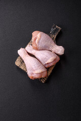 Raw chicken legs with salt, spices and herbs