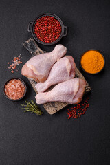 Raw chicken legs with salt, spices and herbs