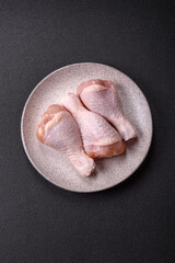 Raw chicken legs with salt, spices and herbs