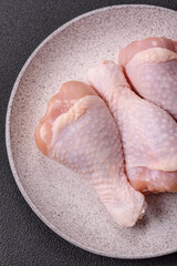 Raw chicken legs with salt, spices and herbs