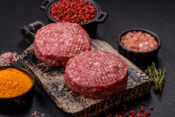 Fresh raw ground beef burger patty with salt and spices