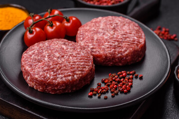 Fresh raw ground beef burger patty with salt and spices