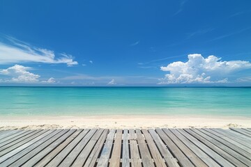 Fototapeta premium A beautiful beach scene with a wooden deck, clear turquoise waters, and a bright blue sky with soft clouds