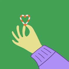 Hand in sweater is holding candy canes in heart shape. Love Christmas print vector illustration