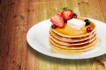 Buttermilk Pancakes with butter and maple syrup for breakfast.