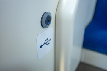 modern bus interior of passenger cabin with gadget USB charging port on handrail. Inside of city...