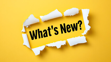 Torn Yellow Paper Revealing 'What's New?' Text