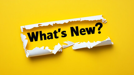 Torn Yellow Paper Revealing 'What's New?' Text