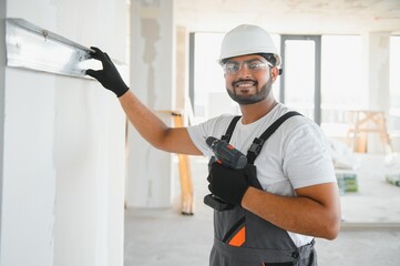 man fasten metal profile frame to the wall for draywall bulkhead