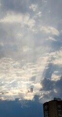 The clouds in sky. In the evening sky there are cumulus and cirrus clouds. They are at different...