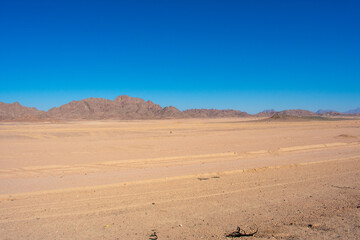 Road in middle of desert near Hurghada Egypt. Empty Asphalt road against blue sky