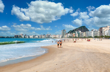 Copacabana beach in Rio de Janeiro, Brazil. Copacabana beach is the most famous beach in Rio de Janeiro. Men running on Copacabana beach