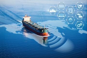 Bulk dry cargo ship underway in sea with AI Logistic and transportation technology. International...