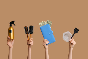 Female hands with  hairdresser's supplies and wallet on color background