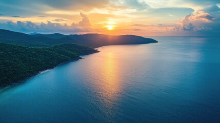 Naklejka premium Sunset Over Lush Green Island Coastline And Ocean