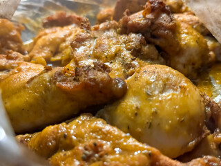 Golden chicken in an oven baking bag close-up. Cooking whole chicken inside cooking bag in oven. Tasty chicken dinner in the oven at home. A baking tray with chicken pieces in the oven. 