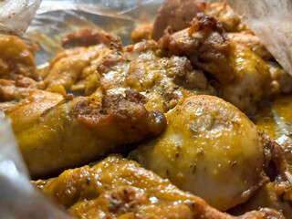 Golden chicken in an oven baking bag close-up. Cooking whole chicken inside cooking bag in oven. Tasty chicken dinner in the oven at home. A baking tray with chicken pieces in the oven. 