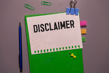 disclaimer text on paper on grey notice board.