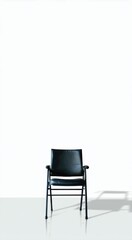 Fototapeta premium Black chair sitting in front of a white wall, space for text