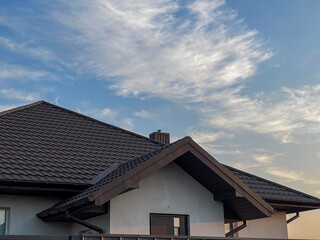 Metal roof design. Roof flashing newly built roof using metal tiles.