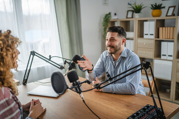 adult man interviewer ask woman guest questions while record podcast