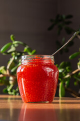 A jar of red caviar on the table