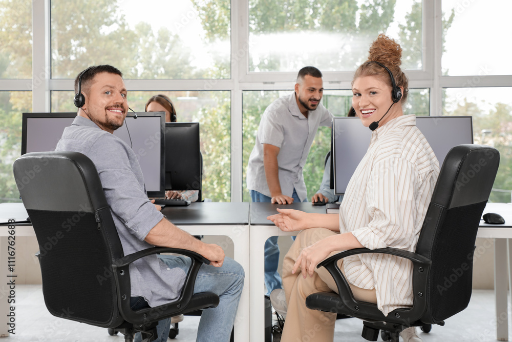 Poster technical support agents working at table in office