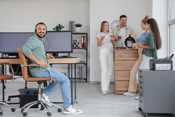 Male technical support agent working at table in office
