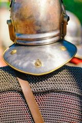 Naklejka premium ancient roman soldier, with metallic armour. Roman legionary at a historical festival