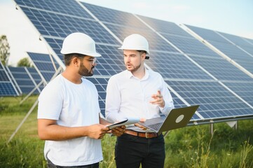 The solar farm, solar panel with two engineers walk to check the operation of the system, Alternative energy to conserve the world's energy