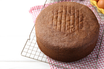 Tasty chocolate sponge cake on white wooden table, closeup