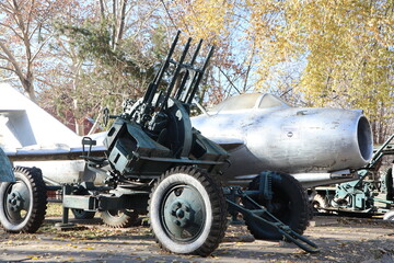 A Historical AntiAircraft Gun Displayed Next to an Aircraft, Showcasing Military Heritage