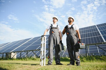 Two workers installing solar panels