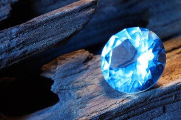 Beautiful shiny light blue gemstone on stone, closeup