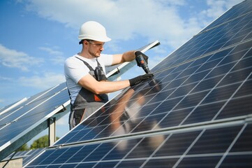 Worker installing solar panels outdoors