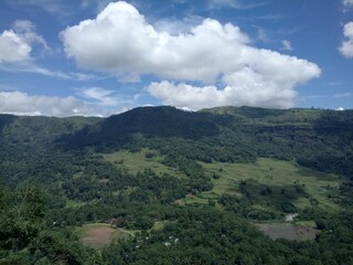 The photograph presents a sweeping vista of a mountainous region, captured from an elevated...