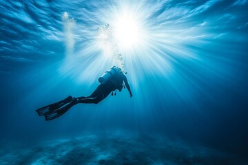 Diver explores underwater depths with sunlight rays creating a serene marine adventure