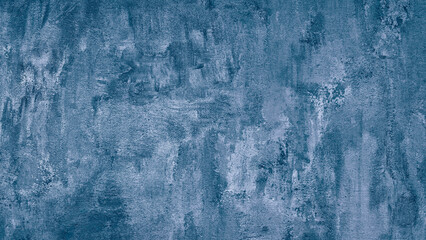 A blue wall with a textured surface. The wall is painted in a light blue color. The wall has a rough texture