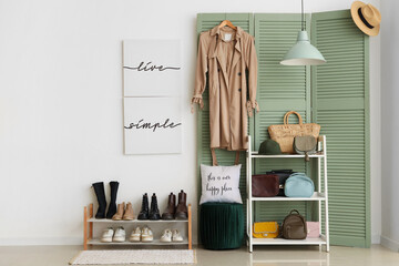 Interior of hall with green folding screen, shoe stand and shelf unit