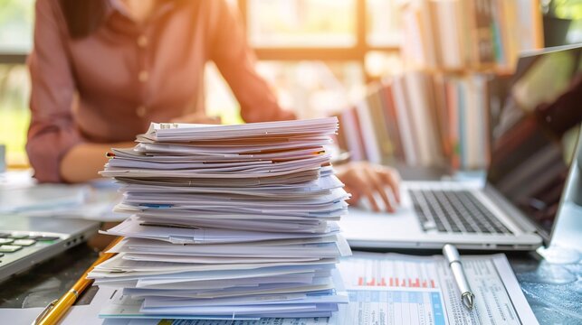 Organized and Efficient Workspace with Laptop Computer Paperwork and Office Supplies Arranged on Desk for Business Research and Administrative Tasks