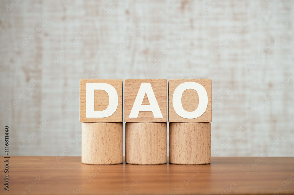 Aufkleber there is wood cube with the word dao. it is an abbreviation for decentralized autonomous organizatio