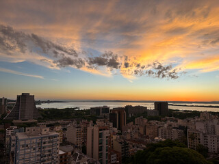 Fototapeta premium Aerial view of the central area of Porto Alegre with the Guaiba River in the background - sunset with clouds