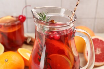 Delicious punch with rosemary in jug, closeup