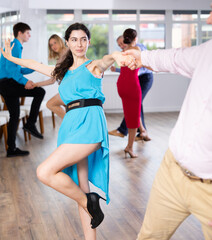 Naklejka premium Women dancing in dance class with partners romantic paso doble