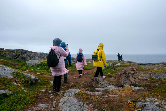 Exploring the Arctic Tundra With Hikers in Colorful Rain Gear