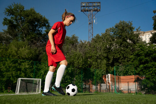 Fototapeta Female soccer player training with the ball