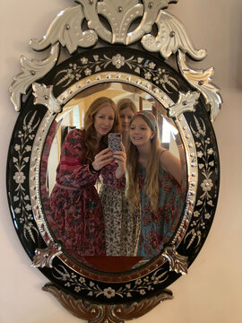A Mum takes a mirror selfie with her teen daughters